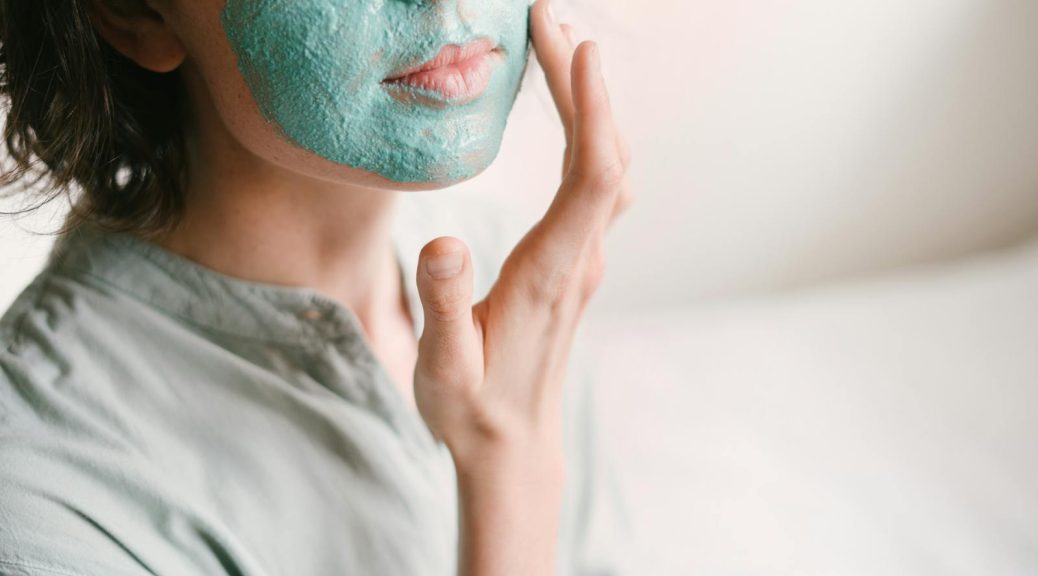 Woman Putting Medicated Cream On Her Face